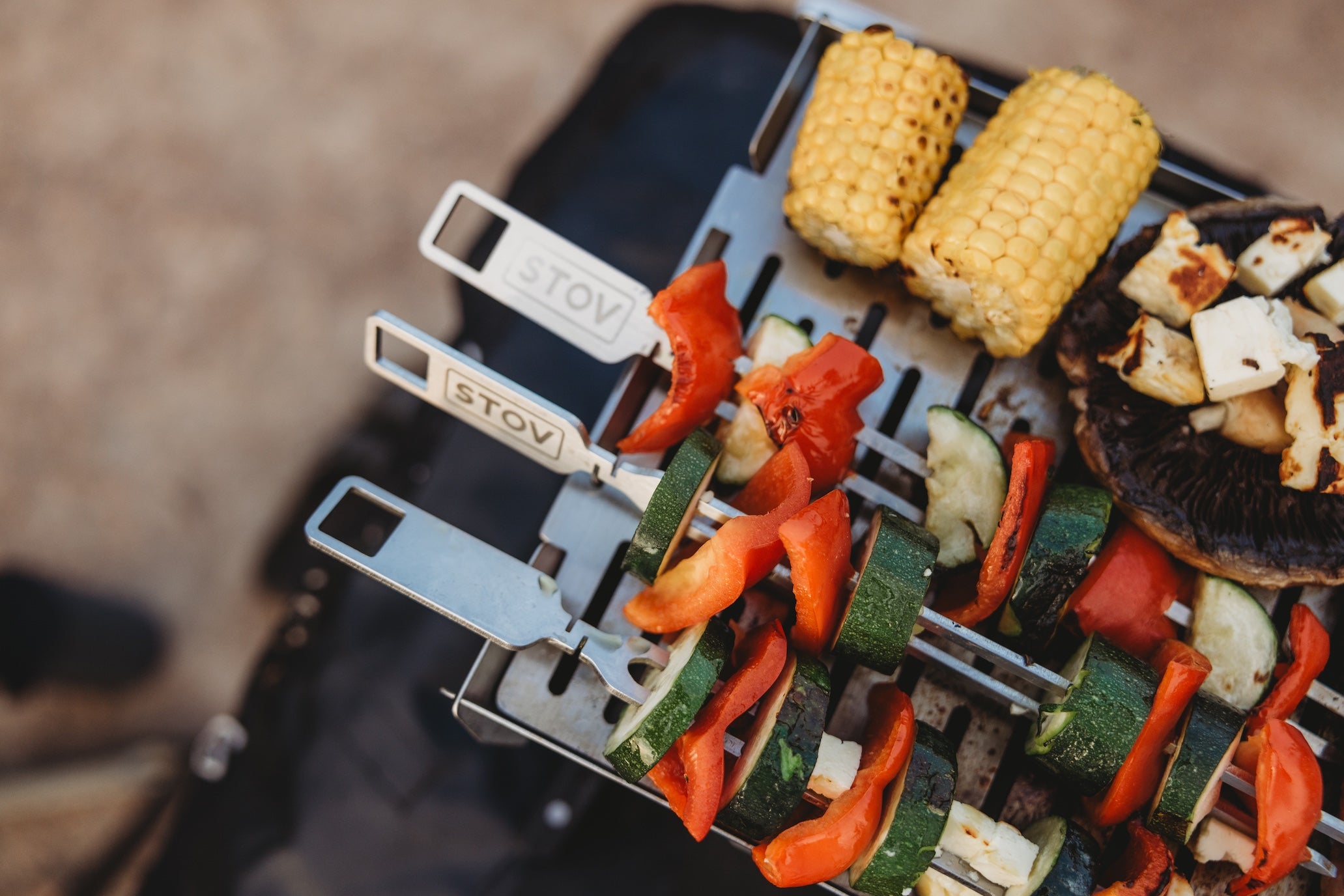 Marinated food cooking on the STOV BBQ with the STOV Skewers getting ready for bbqing.