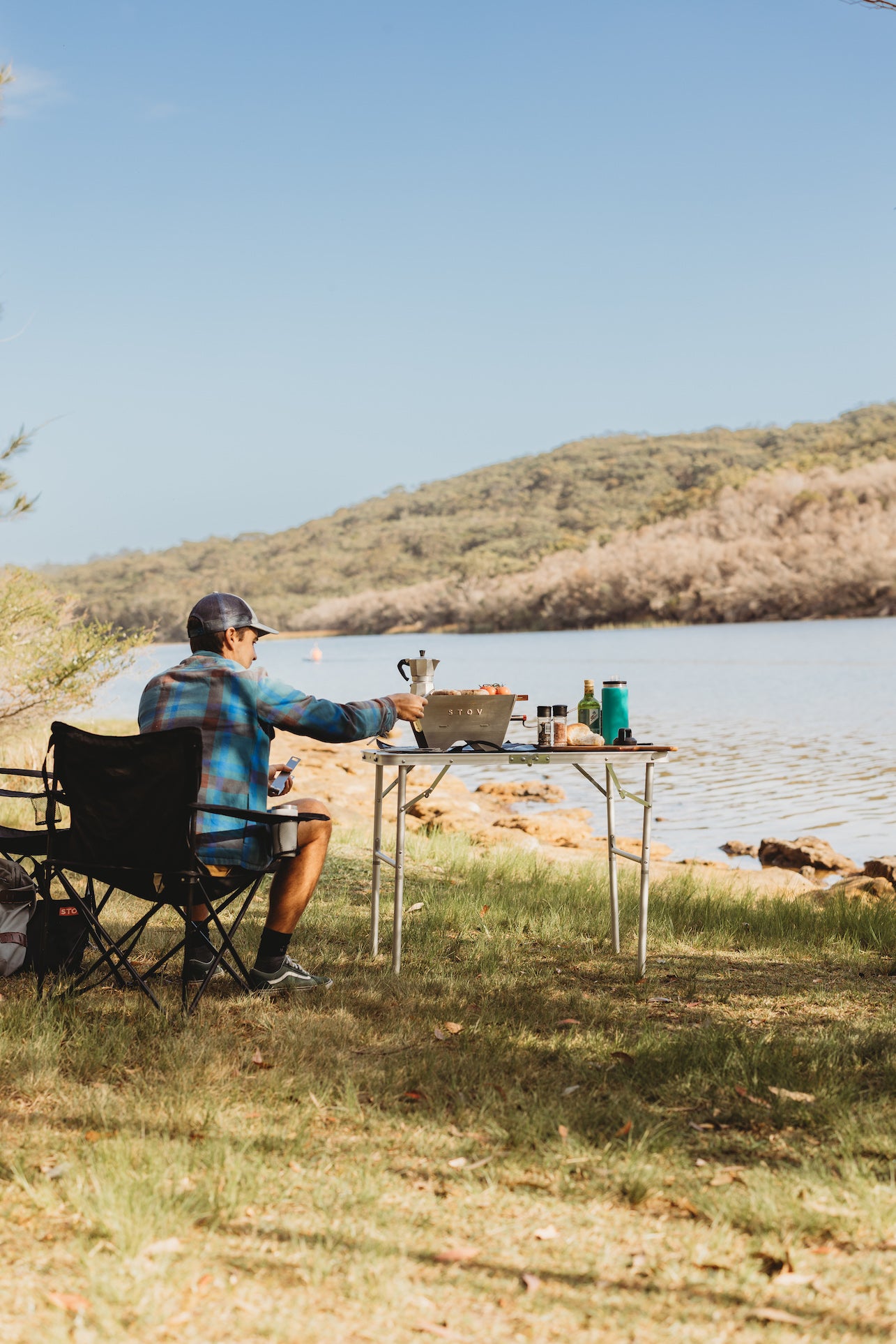 Outdoor cooking and barbecuing at its best with the STOV BBQ by a lake in the mountains.